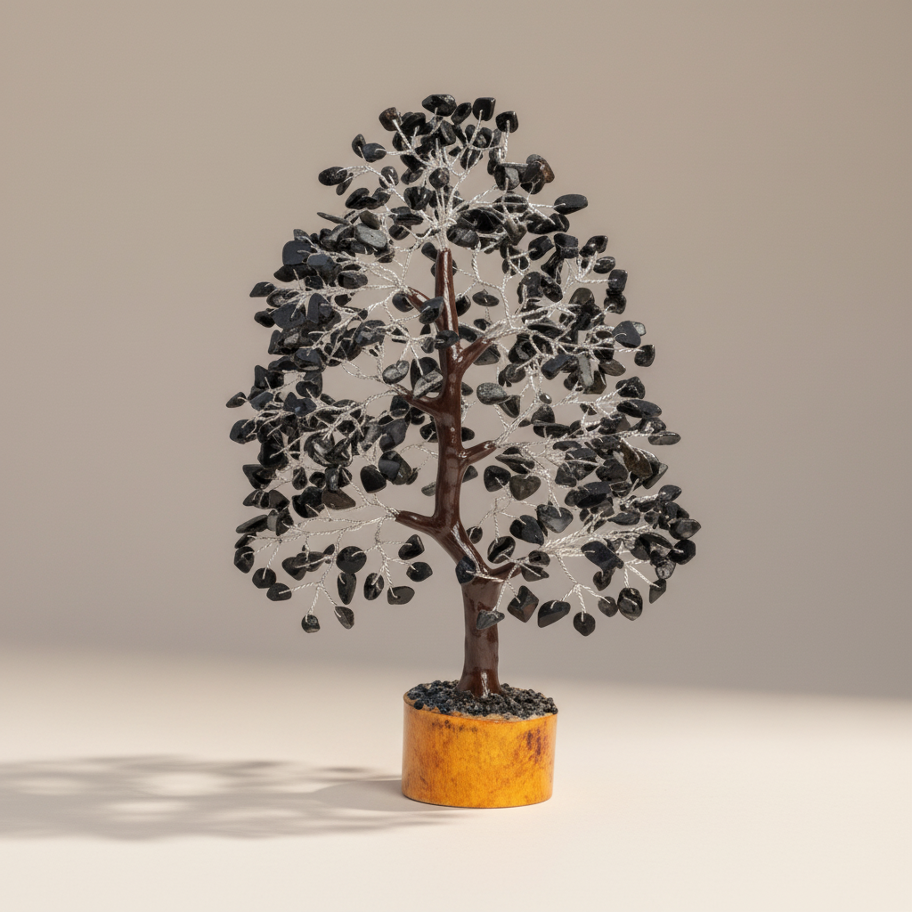 Black Tourmaline crystal tree with dark chips, branching trunk, and warm wood base on a neutral background