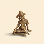 Seated antique-gold Indra Dev idol on a warm studio background