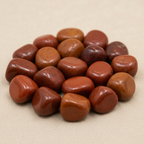 Close-up of smooth polished Red Jasper tumble stones with earthy red mottling