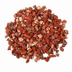 Close-up pile of Red Jasper crystal chips on a light background