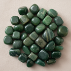 Close-up of smooth polished Green Jade tumble stones with deep green translucency