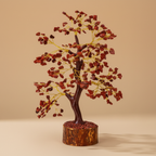Close three-quarter view of a Red Jasper crystal tree with red chips and golden branching
