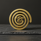Gold-brass Helix spiral decor displayed on dark natural stone