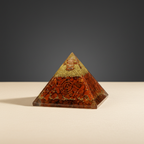 Rich red jasper crystal pyramid on a premium studio background