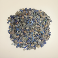 Lapis Lazuli Chips spread on a warm studio surface