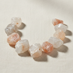 Close-up of irregular white, cream, gray, blush, and peach Multi-Moonstone Crystal Chips