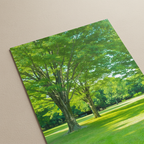 Close-up detail of the GREEN-LUSH poster showing vivid green foliage, trees, and sunlit grass