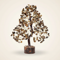 Tiger Eye crystal tree with golden-brown chips, dark trunk, and warm wood base on an ivory background