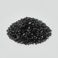 Loose Black Tourmaline tumbled stones and dark crystal chips arranged on a light studio background