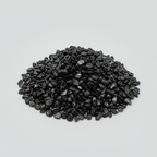 Loose Black Tourmaline tumbled stones and dark crystal chips arranged on a light studio background
