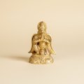 Garud Dev golden statue on a warm ivory studio background
