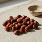 Polished Red Jasper tumble stones arranged on a neutral linen surface