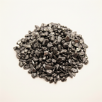 Close-up pile of Hematite crystal chips on a light background